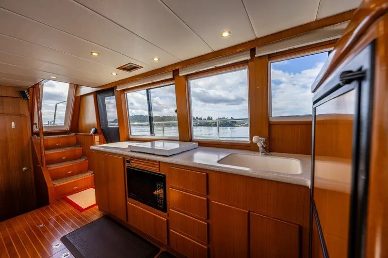  Yacht Photos Pics Interior of 2000 Symbol 42 Classic Trawler with wooden cabinetry and large windows.