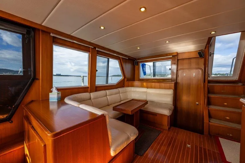  Yacht Photos Pics Luxurious interior of 2000 Symbol 42 Classic Trawler with wood paneling and plush seating.