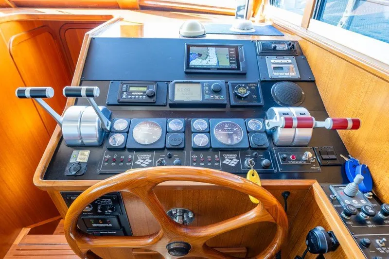  Yacht Photos Pics Control panel of a 2000 Symbol 42 Classic Trawler with wooden steering wheel and navigation instruments.