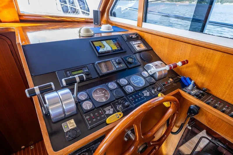  Yacht Photos Pics Control panel of 2000 Symbol 42 Classic Trawler with navigation instruments and wooden steering wheel.
