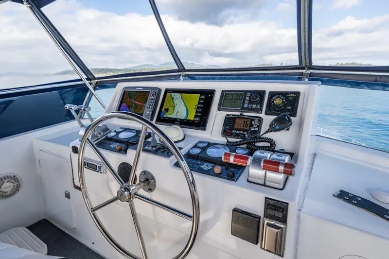  Yacht Photos Pics Helm of 2000 Symbol 42 Classic Trawler with navigation instruments and steering wheel.