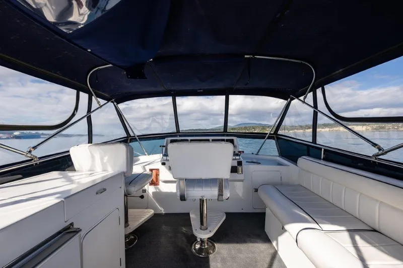  Yacht Photos Pics Interior view of 2000 Symbol 42 Classic Trawler with white seating and ocean backdrop.
