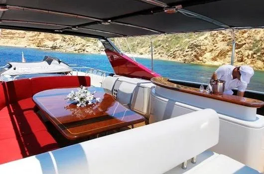  Yacht Photos Pics Luxurious 2005 Couach 2800 FLY yacht interior with red seating and elegant dining area.