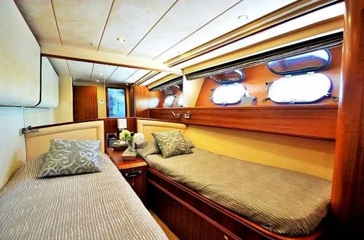  Yacht Photos Pics Luxurious cabin interior of 2005 Couach 2800 FLY yacht with twin beds and elegant decor.