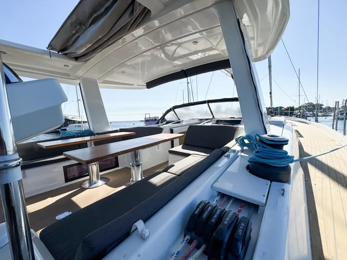  Yacht Photos Pics 2019 Hanse 588 yacht deck with seating and winches, docked at marina.