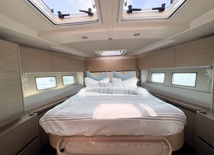  Yacht Photos Pics Luxurious cabin interior of 2019 Hanse 588 yacht with skylights and cozy bedding.