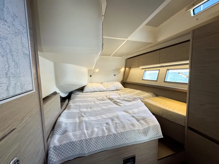  Yacht Photos Pics Luxurious cabin interior of 2019 Hanse 588 yacht with cozy bed and ocean view.