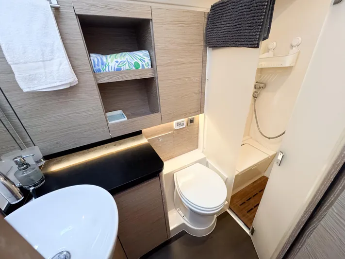  Yacht Photos Pics Modern bathroom in 2019 Hanse 588 yacht with sink, toilet, and shower.