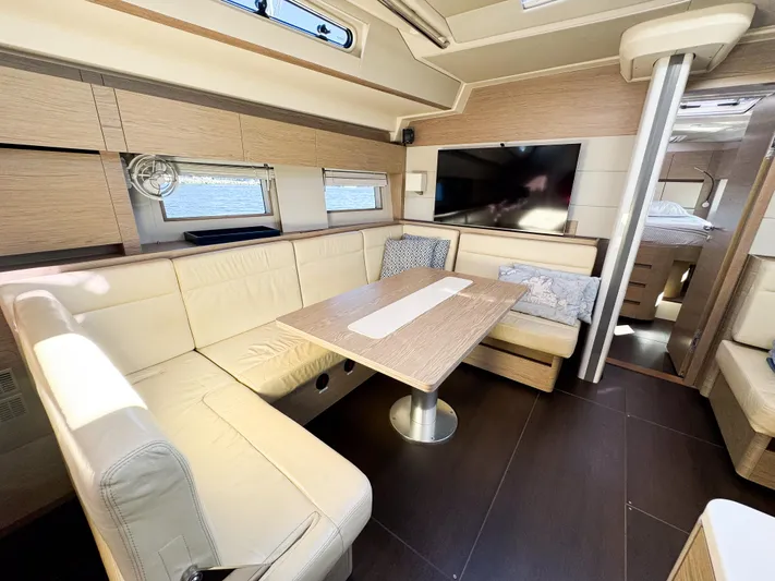  Yacht Photos Pics Luxurious interior of 2019 Hanse 588 yacht with modern seating and dining area.