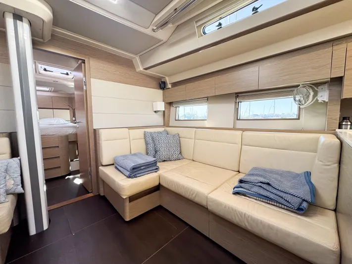  Yacht Photos Pics Luxurious interior of 2019 Hanse 588 yacht with beige seating and cozy decor.
