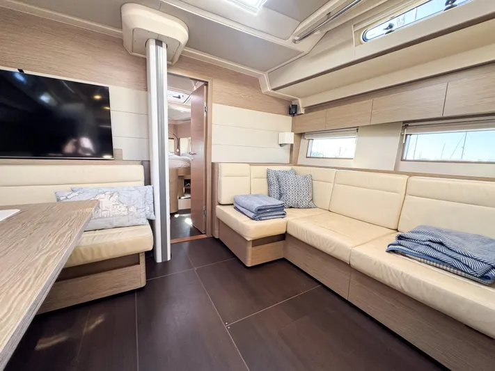  Yacht Photos Pics Luxurious interior of 2019 Hanse 588 yacht with modern seating and decor.