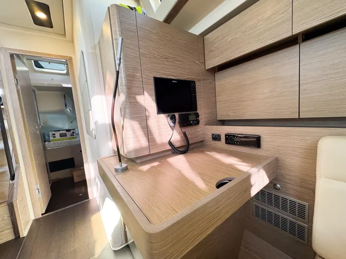  Yacht Photos Pics Modern interior of 2019 Hanse 588 yacht with sleek wooden finishes and built-in electronics.