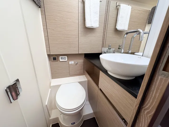  Yacht Photos Pics Modern bathroom in 2019 Hanse 588 yacht with sleek fixtures and wood cabinetry.