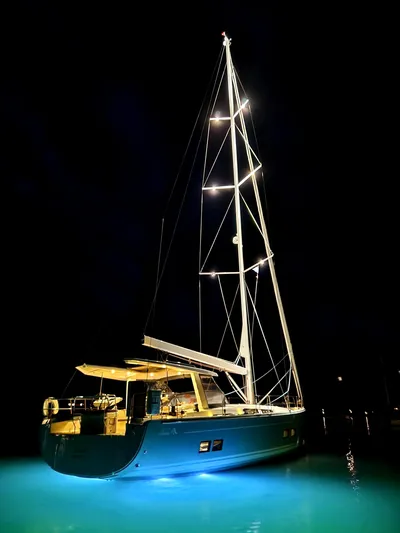  Yacht Photos Pics 2019 Hanse 588 yacht illuminated at night with glowing blue water.