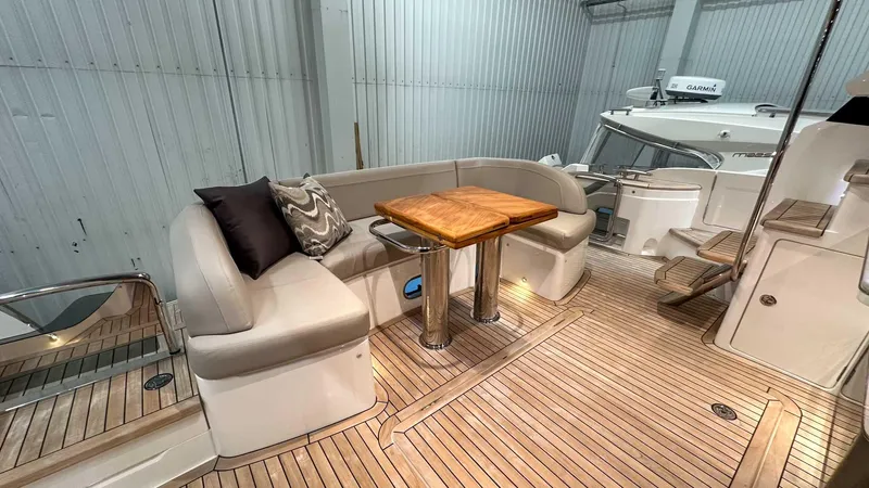 F55163 Yacht Photos Pics Luxurious 2023 Princess F55 yacht interior with elegant seating and wooden table.