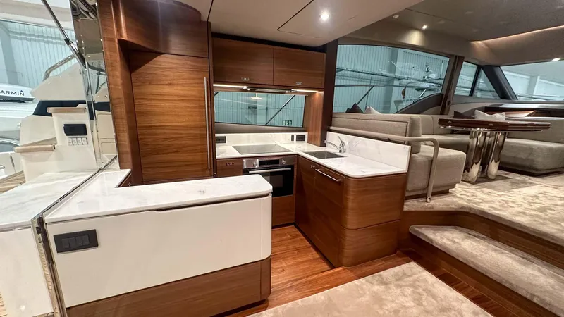 F55163 Yacht Photos Pics Luxurious interior of 2023 Princess F55 yacht with modern kitchen and seating area.