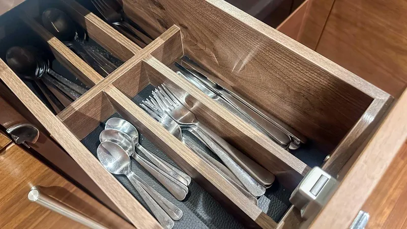 F55163 Yacht Photos Pics Wooden cutlery drawer with organized silverware in a Princess F55, 2023 model.