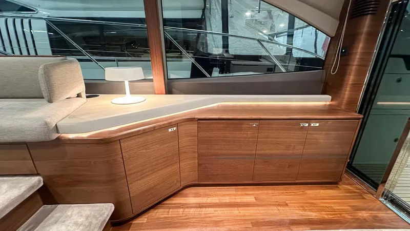 F55163 Yacht Photos Pics Luxurious interior of 2023 Princess F55 yacht with elegant wood cabinetry and modern lighting.