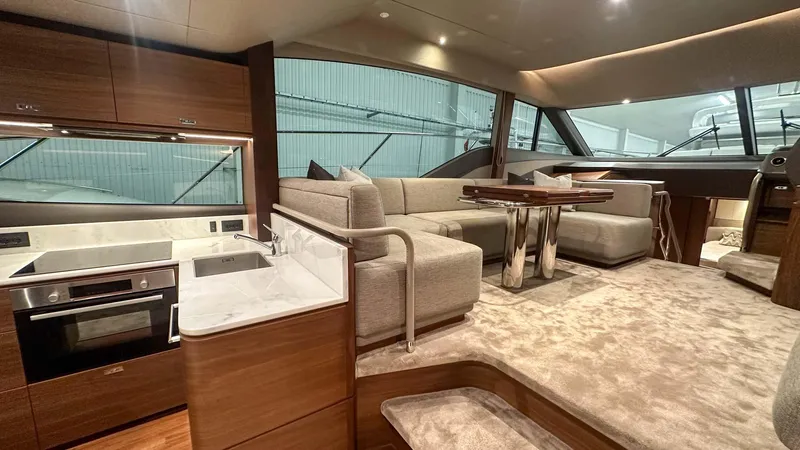 F55163 Yacht Photos Pics Luxurious interior of 2023 Princess F55 yacht with modern kitchen and seating area.