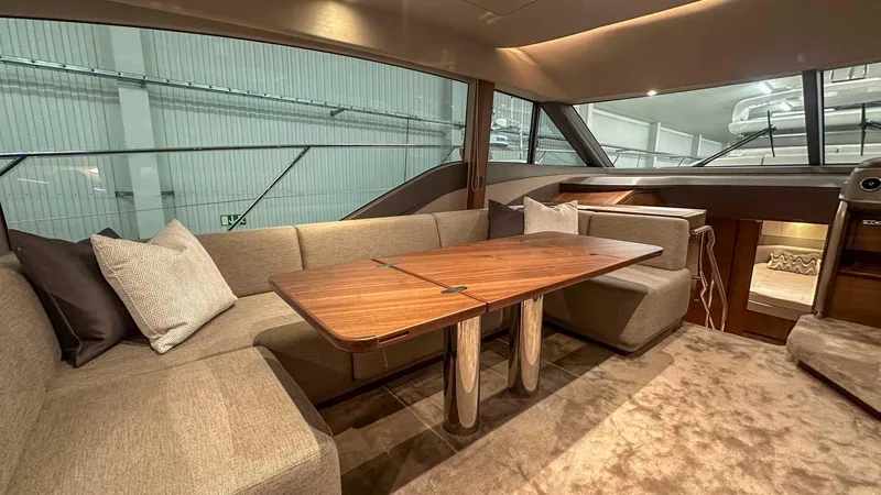 F55163 Yacht Photos Pics Luxurious interior of 2023 Princess F55 yacht with elegant seating and wooden table.