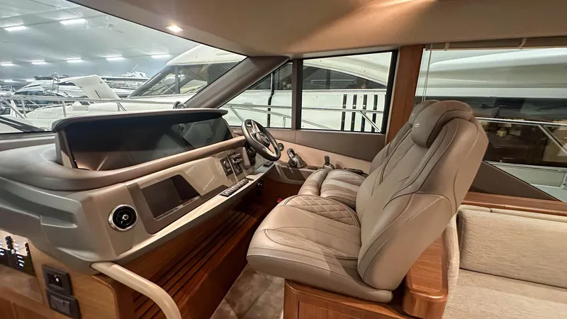 F55163 Yacht Photos Pics Luxurious interior of 2023 Princess F55 yacht with modern helm and plush seating.