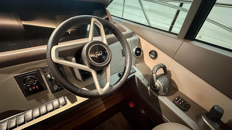 F55163 Yacht Photos Pics 2023 Princess F55 yacht helm with steering wheel and control panel.