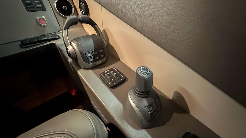 F55163 Yacht Photos Pics Control panel of 2023 Princess F55 yacht with joystick and steering wheel.