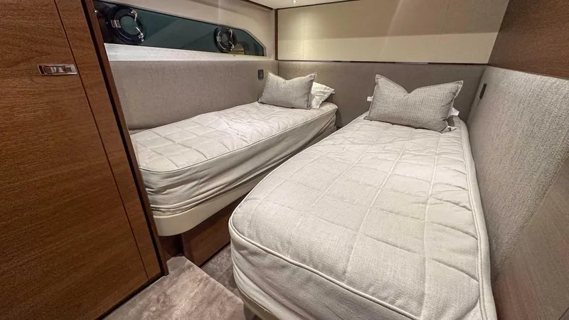 F55163 Yacht Photos Pics Luxurious twin cabin in 2023 Princess F55 yacht with modern decor and comfortable bedding.