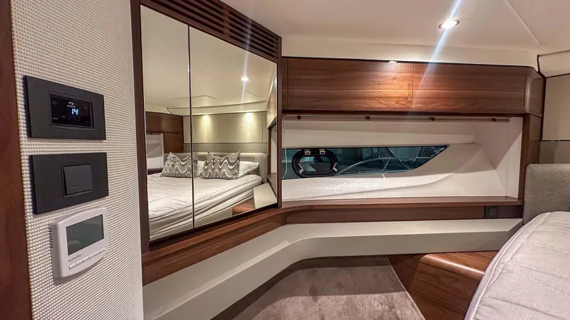 F55163 Yacht Photos Pics Luxurious interior of 2023 Princess F55 yacht with elegant wood finishes and mirrored accents.