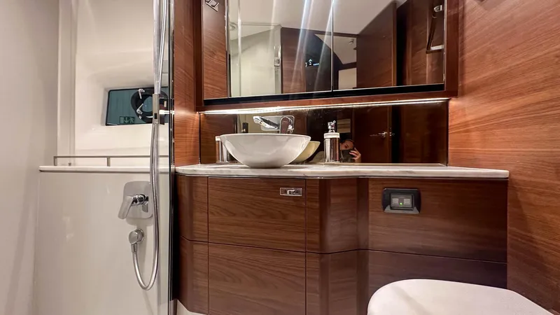 F55163 Yacht Photos Pics Luxurious bathroom in 2023 Princess F55 yacht with modern wood finish and elegant fixtures.