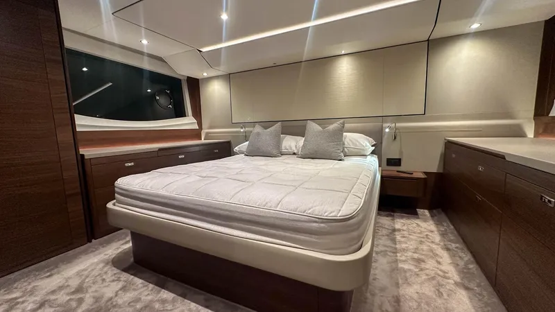 F55163 Yacht Photos Pics Luxurious bedroom interior of 2023 Princess F55 yacht with modern design and elegant furnishings.