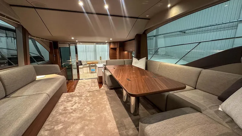 F55163 Yacht Photos Pics Luxurious interior of 2023 Princess F55 yacht with elegant seating and wooden table.