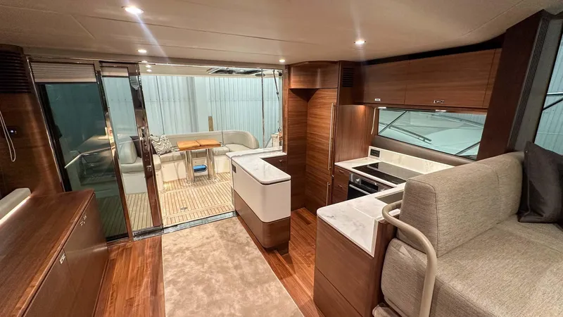 F55163 Yacht Photos Pics Luxurious interior of 2023 Princess F55 yacht with modern kitchen and seating area.