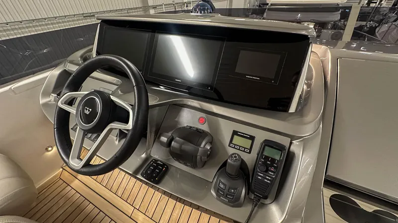 F55163 Yacht Photos Pics Control panel of 2023 Princess F55 yacht with steering wheel and navigation instruments.