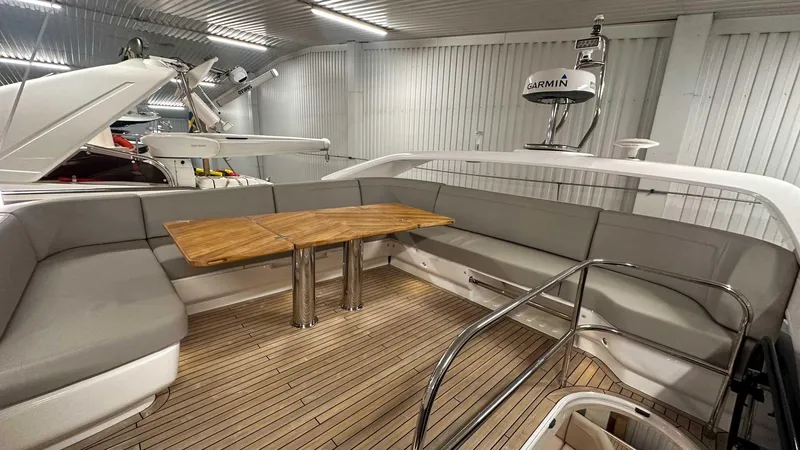 F55163 Yacht Photos Pics Luxurious 2023 Princess F55 yacht interior with elegant seating and wooden table.