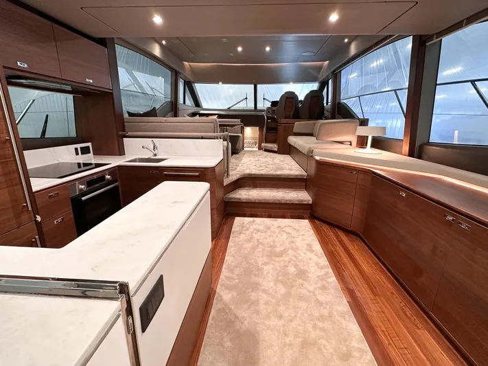 F55163 Yacht Photos Pics Luxurious interior of 2023 Princess F55 yacht with modern kitchen and seating area.