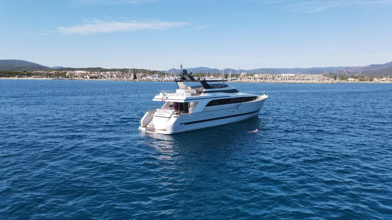 Lady Moh Yacht Photos Pics Luxury Bugari 95 yacht from 2002 cruising on a serene blue sea.