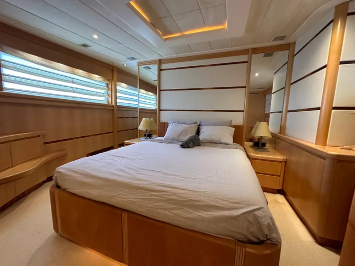 Lady Moh Yacht Photos Pics Luxurious bedroom interior of 2002 Bugari 95 yacht with modern design and ambient lighting.