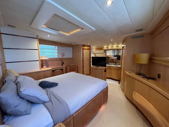 Lady Moh Yacht Photos Pics Luxurious bedroom interior of a 2002 Bugari 95 yacht with modern furnishings.