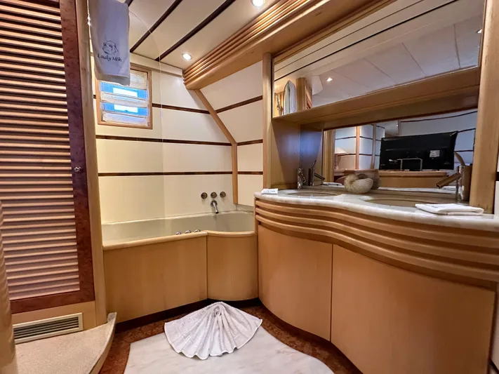 Lady Moh Yacht Photos Pics Luxurious bathroom in a 2002 Bugari 95 yacht with elegant wooden finishes.