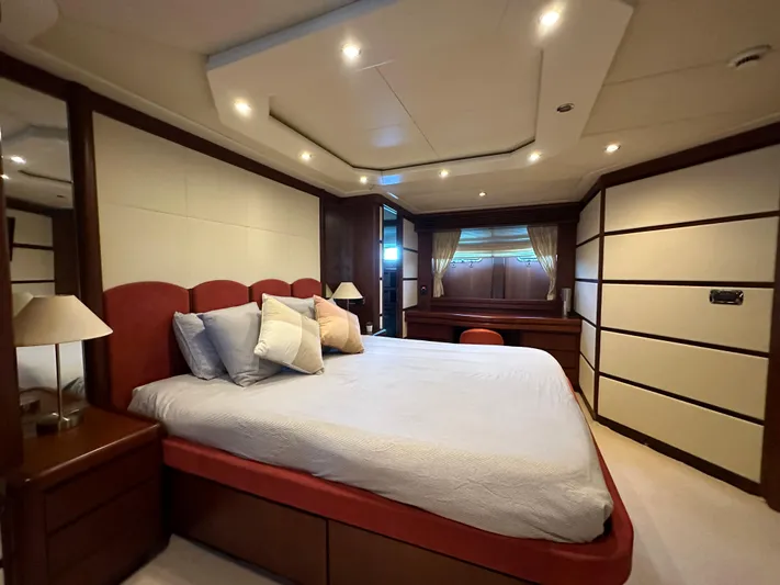 Lady Moh Yacht Photos Pics Luxurious bedroom on a 2002 Bugari 95 yacht with modern decor and ambient lighting.