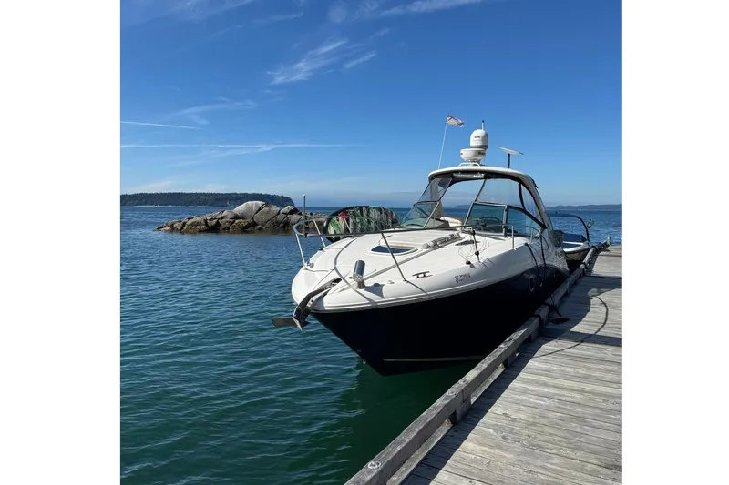  Yacht Photos Pics 2013 Sea Ray 330 Sundancer docked by a scenic rocky shoreline.