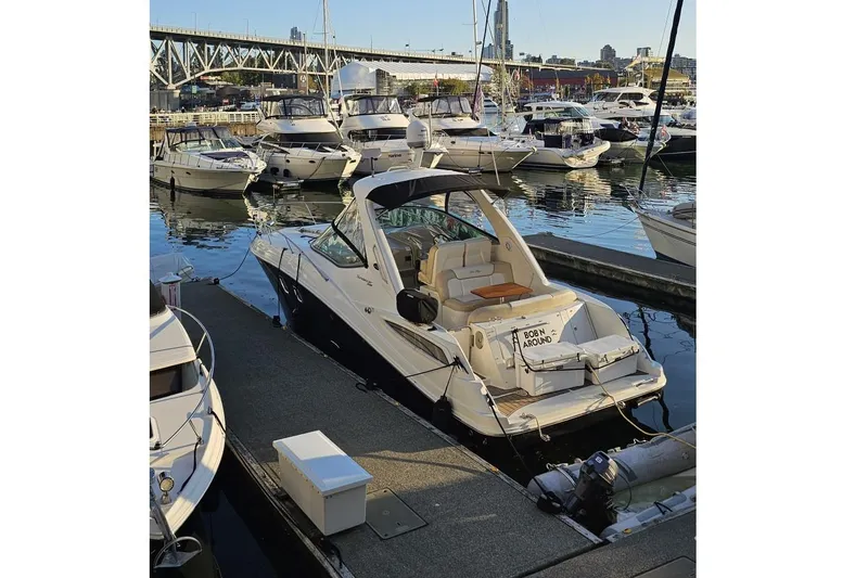  Yacht Photos Pics 2013 Sea Ray 330 Sundancer docked at marina with cityscape background.