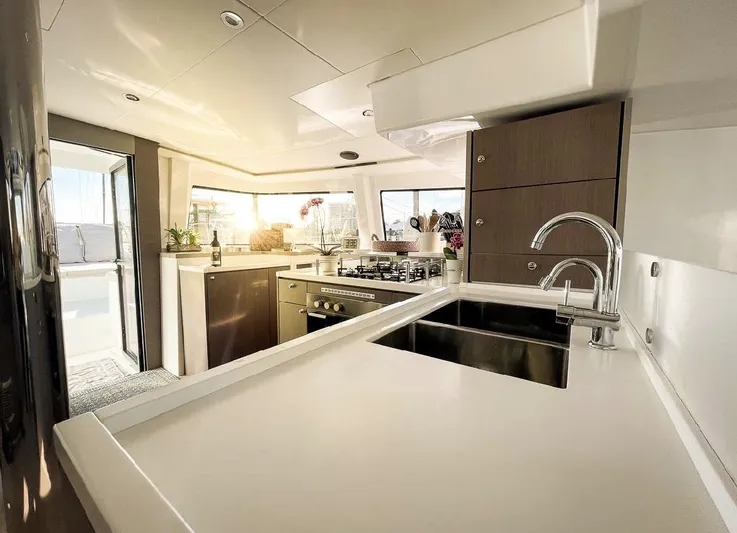  Yacht Photos Pics Luxurious kitchen interior of 2021 Bali 4.8 yacht with modern appliances and sunlight.
