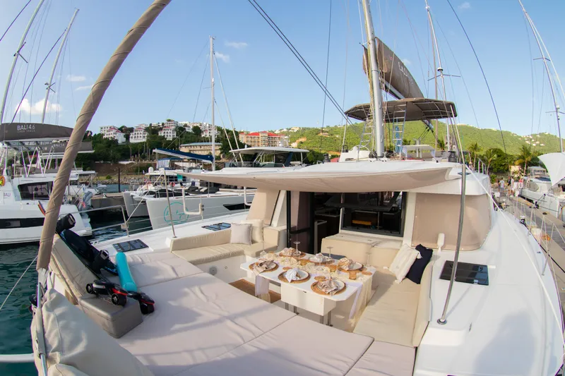  Yacht Photos Pics Luxurious 2021 Bali 4.8 catamaran with elegant outdoor dining setup in marina.