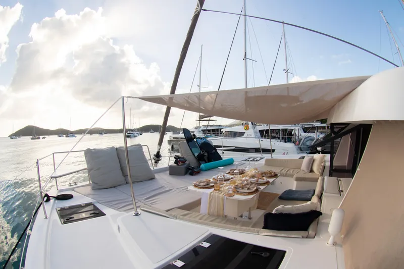  Yacht Photos Pics Luxurious 2021 Bali 4.8 yacht with elegant outdoor dining setup at sunset.