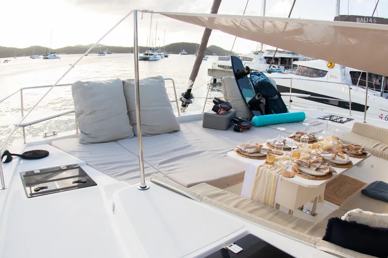  Yacht Photos Pics Luxurious Bali 4.8 catamaran deck with elegant dining setup, 2021 model, docked at sunset.