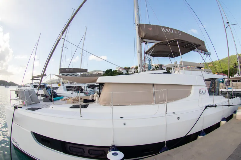  Yacht Photos Pics 2021 Bali 4.8 catamaran docked at marina, clear sky, calm waters.