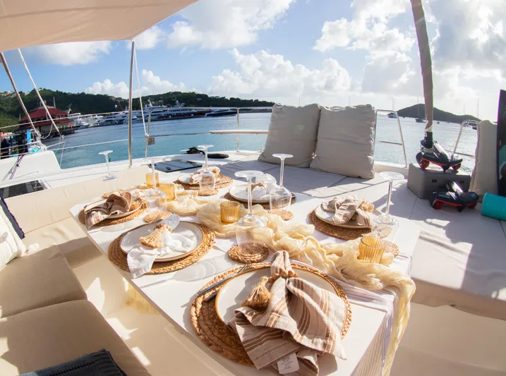  Yacht Photos Pics Luxurious dining setup on a 2021 Bali 4.8 yacht, overlooking a serene marina.