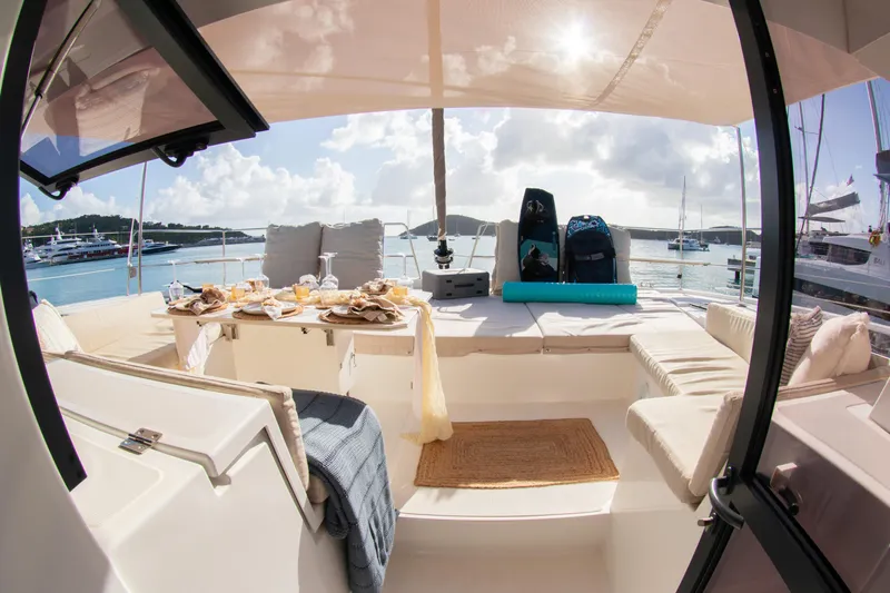  Yacht Photos Pics Luxurious Bali 4.8 catamaran interior with dining setup, 2021 model, docked in a sunny marina.